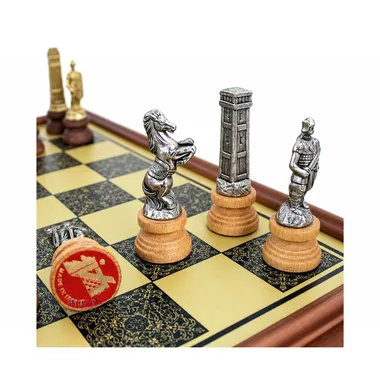 Close-up of metal knight and warrior pieces on the wooden chess board
