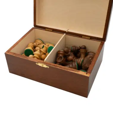 Open storage box with light and dark chess pieces stored inside