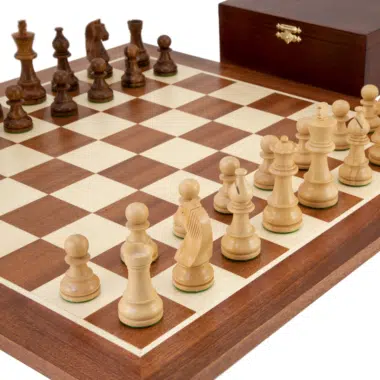 Close-up view of rosewood pieces placed on the maple and mahogany chess board