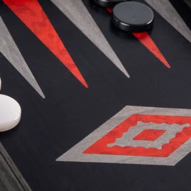 Backgammon set in black and silver oak wood, close-up of red and grey triangles