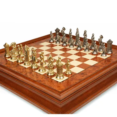 Gold and silver metal chess pieces on briar wood chess board