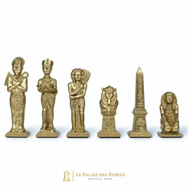 Gold chess pieces with Egyptian theme, king, queen, sphinx and obelisk