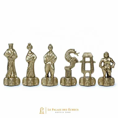 Samurai chess pieces in gold-toned metal, close-up of king, dragon and rook