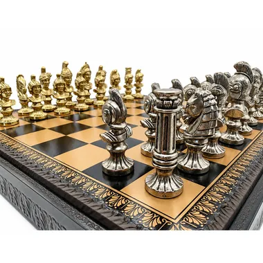 Gold and silver pieces facing each other on the chess board in close-up