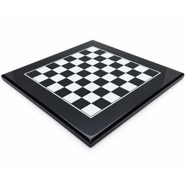 Black lacquered chess board viewed at an angle against a white background