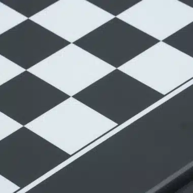 Close-up of the black and white squares on the lacquered chess board