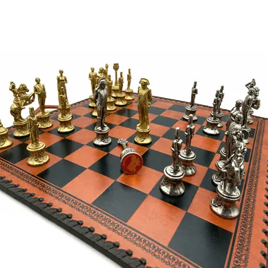 Close-up of gold and silver pieces facing each other on the chess board