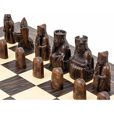 Dark Isle of Lewis resin pieces with carved details on the chessboard