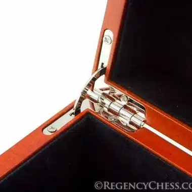 Detailed chrome metal hinge at the corner of the open box