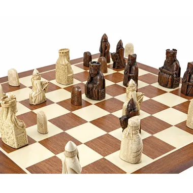 Close-up of Isle of Lewis chess pieces lined up on the wooden board