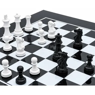 Black and white wooden pieces arranged mid-game on the chessboard