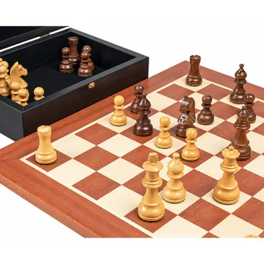 Acacia chess pieces arranged on the mahogany board beside the open box