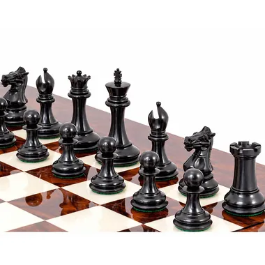 Black ebony pieces lined up on the maple burl chessboard