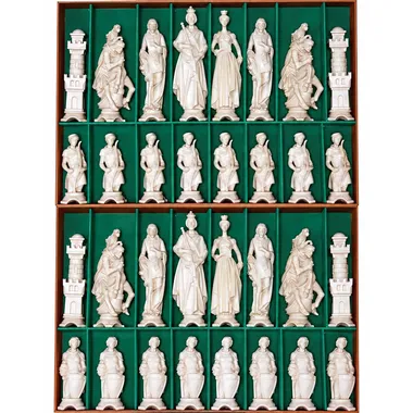 Carved Renaissance chess pieces lined up in their green case