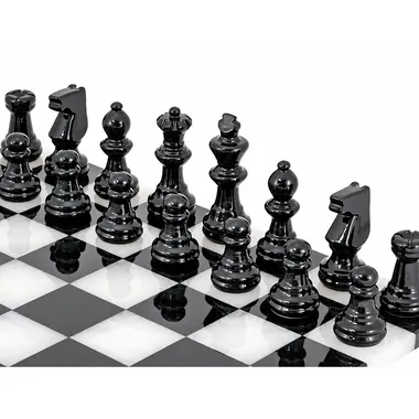 Black marble chess pieces lined up on the board, close-up view