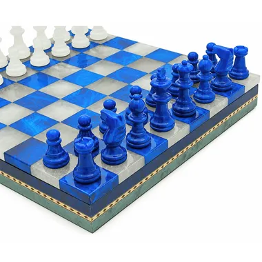 Marble chess board with blue and white pieces, angled view