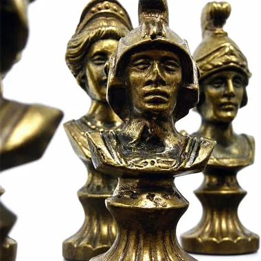 Gold-toned metal chess pieces, detailed Roman busts, close-up view
