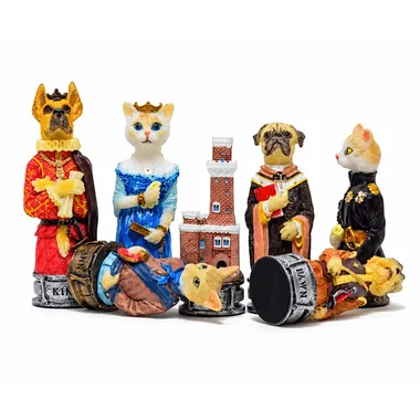 Dogs and cats chess pieces, king lying on the ground near the castle and pawns