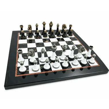 Complete chess set on black and white marble board, gold and silver pieces