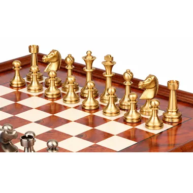 Gold-toned solid brass pieces of the Grand Staunton set lined up on the board