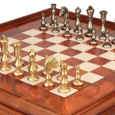 Solid brass chess pieces in gold and silver tones on an elm wood chess board