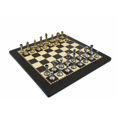 Small metal chess set in gold and silver tones on a dark wood board