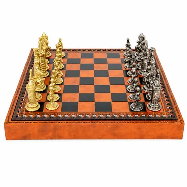 Complete Camelot chess set, gold and silver pieces on a faux-leather chess board