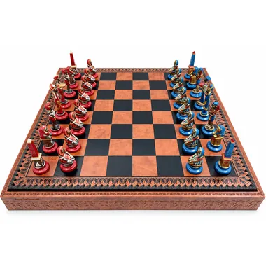 Egyptian chess set with red and blue metal pieces on a faux leather board