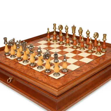 Arabesque chess pieces in metal and wood seen close up on the board