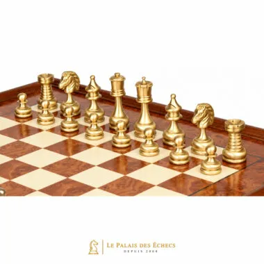 Gold-toned solid brass pieces shown close up on the burl wood board