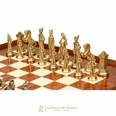 Gold-toned Napoleon chess pieces lined up on the elm wood chess board