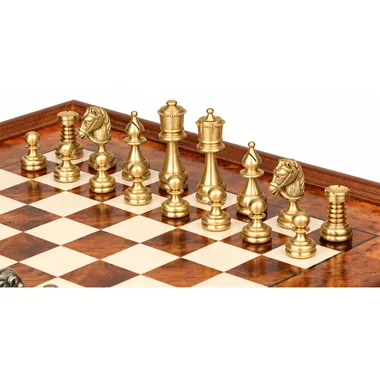Gold-toned solid brass chess pieces lined up on the elm wood chess board