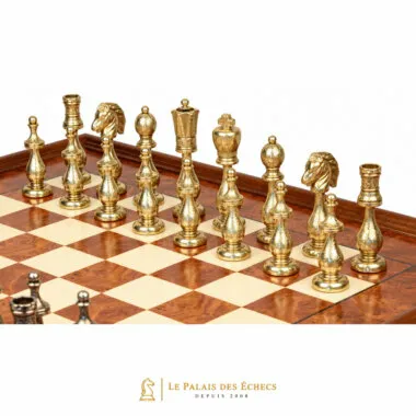 Close-up of the gold-toned metal pieces of the Arabesque chess set on the board
