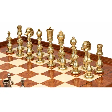 Close-up of the gold-toned metal pieces of the Arabesque chess set on the board