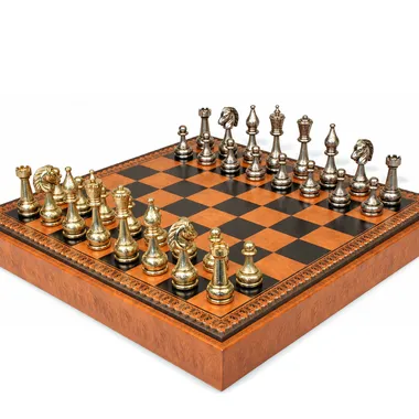 Flowered chess pieces in gold and silver tones, angled view on the board