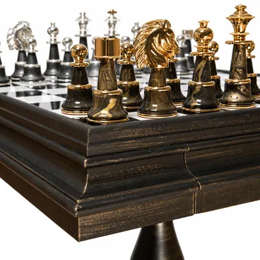 Close-up of solid brass gold pieces, including the knight, on the alabaster chess board