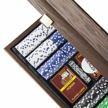 Close-up of coloured poker chips, cards and dice inside the box