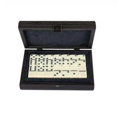Open box showing ivory domino tiles arranged on grey felt