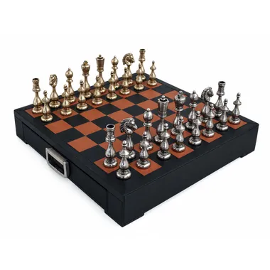 Gold and silver metal chess pieces arranged on the leather chessboard