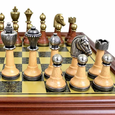Close-up of metal and wooden pieces on the brass-effect board