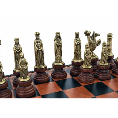 Close-up of golden medieval chess pieces featuring king, queen and figures
