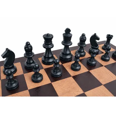 Black Staunton pieces seen close up on the leather chess board squares