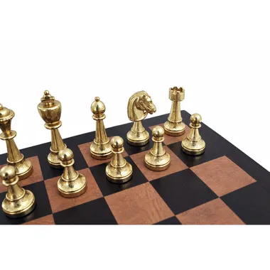 Gold-tone Staunton metal chess pieces arranged on the leather board