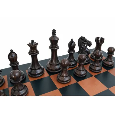 Carved dark pieces: king, queen, bishop and knight on the leather board
