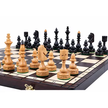 Chess set in light and black wood arranged on the folding board
