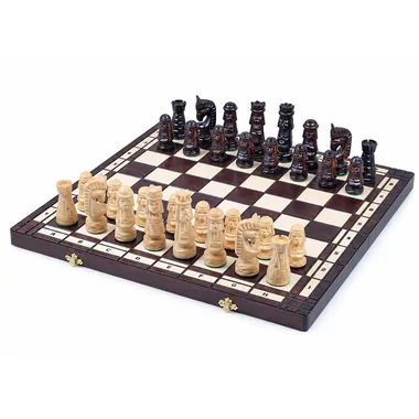 Carved wooden chess set arranged on an open folding board