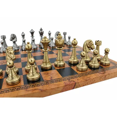Gold-toned Staunton metal pieces close-up on world-map pattern chessboard