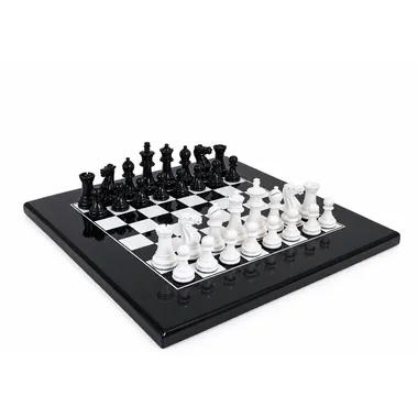 Two-tone black and white chess set, pieces in starting position on lacquered board
