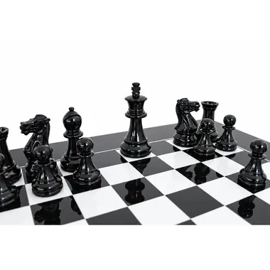 Black pieces close-up facing the white pieces on the lacquered board