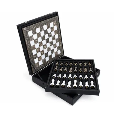 Open black storage box with marble chessboard and pieces nestled in their slots